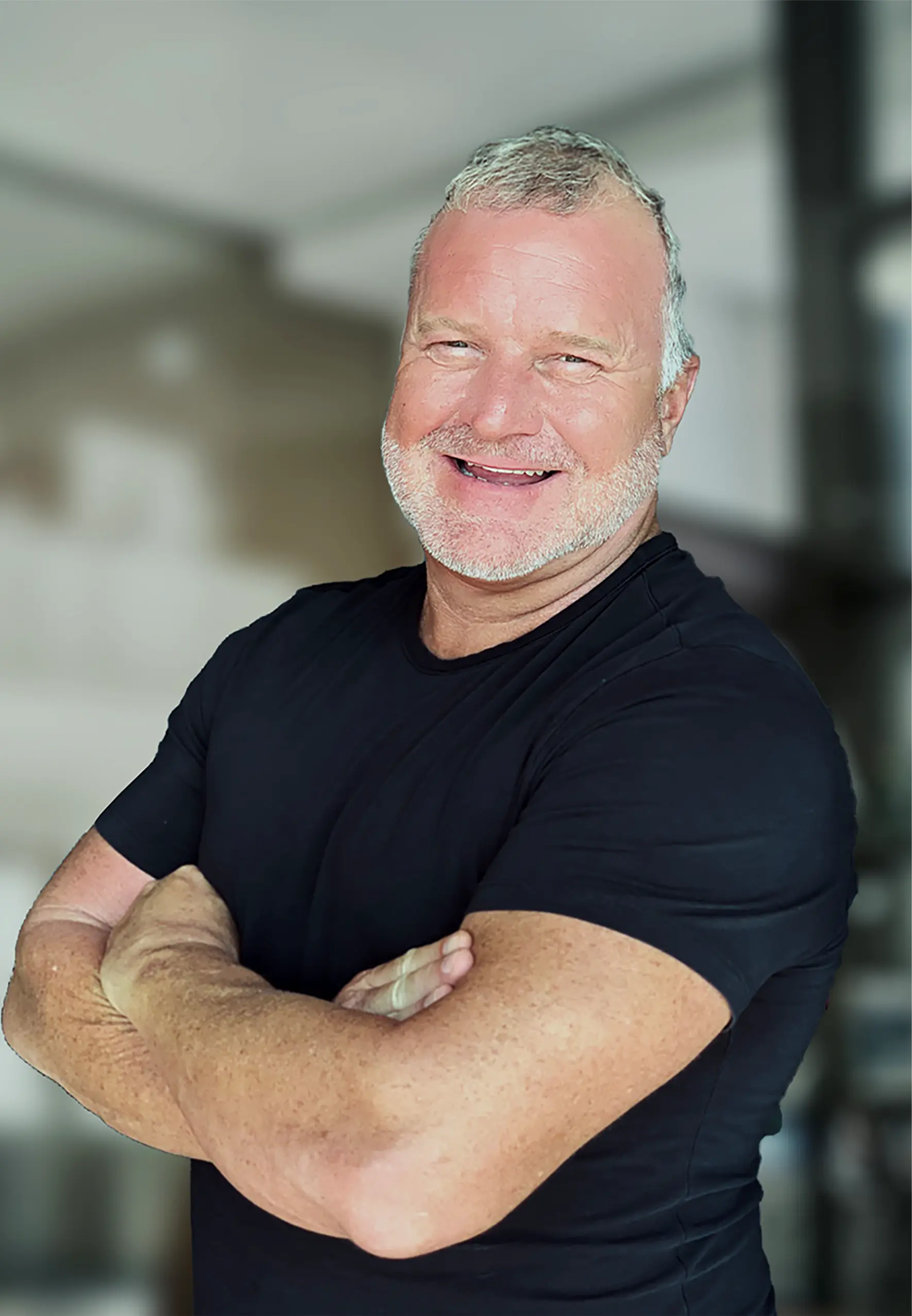 Chris S. Reynolds, author of The Six Circle Strategy: The Entrepreneur’s Journey to Wealth and Freedom, smiling with arms crossed in a black t-shirt.